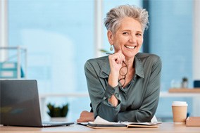 Woman smiling at a desk